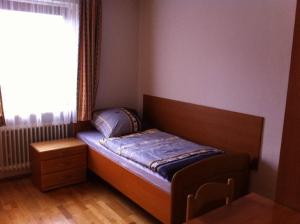 a small bed in a room with a window at Appartment München Isartor in Munich