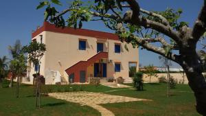 a large white building with a red roof at Terra e colori in Gallipoli