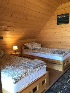 A bed or beds in a room at Domek na Hubce