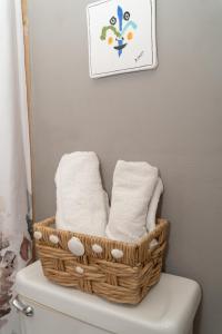 a basket of towels sitting on top of a toilet at Apartment in Villas Del Faro Resort with WIFI in Maunabo