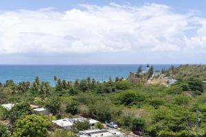 a view of the ocean from a hill at Apartment in Villas Del Faro Resort with WIFI in Maunabo