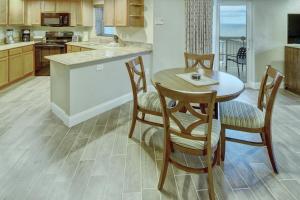 a kitchen with a table and chairs in a room at Club Wyndham Royal Vista in Pompano Beach