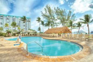 a swimming pool at a resort with palm trees at Club Wyndham Royal Vista in Pompano Beach