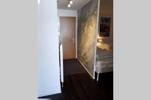 a room with a bed and a wall with a map at Cristal 28 in Leukerbad