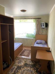 a small room with two beds and a window at Gostevoy Dom Magadan in Anapa