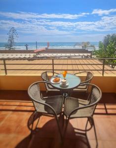 a table and chairs with a plate of food on a balcony at Primera línea Morro de Goss in Oropesa del Mar