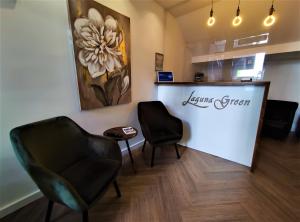 a waiting room with two chairs and a counter at Laguna Green Guest House in Niš