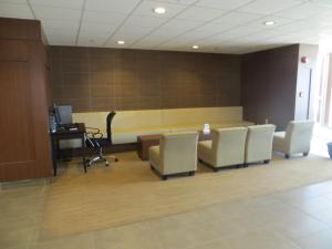 a lobby with a waiting room with chairs and a desk at New Lodge Winnipeg in Winnipeg