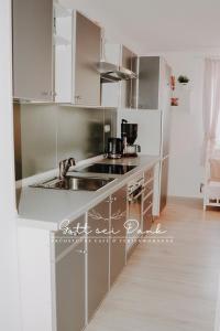 a kitchen with white cabinets and a sink at Ferienwohnung "Gott sei Dank" in Herzberg am Harz