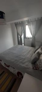 a bed with pillows on it in a bedroom at Apartament central. Bloc nou. in Bacău