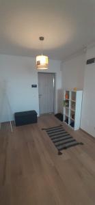 an empty room with a couch and a rug at Apartament central. Bloc nou. in Bacău
