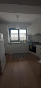 an empty kitchen with a window and a stove at Apartament central. Bloc nou. in Bacău