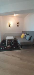 a living room with a couch and a table at Apartament central. Bloc nou. in Bacău
