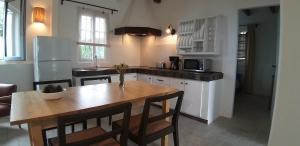 a kitchen with a wooden table and a dining room at Finca Verode in Santa Cruz de Tenerife