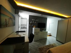 a room with a kitchen with a refrigerator and a table at Apartmani Vera in Bibinje +53 photos