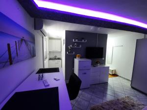 a living room with a purple lighting in a room at Apartmani Vera in Bibinje
