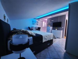 a bedroom with a bed with blue lights on it at Apartmani Vera in Bibinje