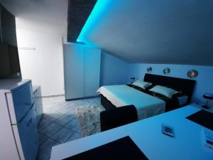 a bedroom with a bed and a table and a tv at Apartmani Vera in Bibinje