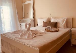 een bed met een jurk en een dienblad erop bij Ouranias Guesthouse in Chania