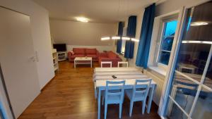 a living room with a table and chairs and a couch at Finkennest Wolke 7 in Carolinensiel