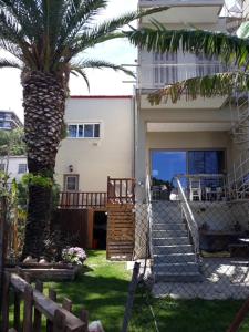 a palm tree in front of a house with stairs at Sweet home in Aigio in Aigio