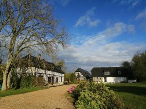 a village with two white buildings and a tree at Le Domaine des Tostes in Bonneville-la-Louvet