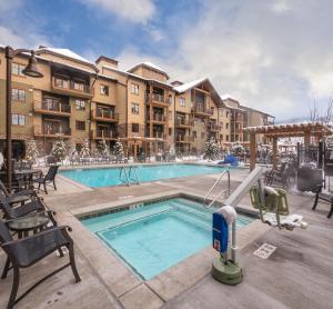 a pool at a hotel with chairs and a resort at Club Wyndham Park City in Park City