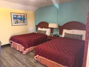 A bed or beds in a room at America's Value Inn