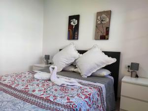 A bed or beds in a room at Los Cristianos - heated swimming pool air-conditioned