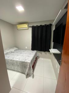 a small bedroom with a bed and a window at Ap no campo dos velhos com ar in Sobral