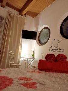 a bedroom with a bed and a window and a table at B&B Villa Ginestra in Pescara