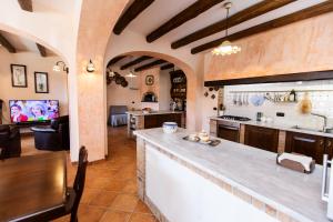 a kitchen with a bar and a living room at San Nicola in Agerola