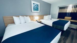 a hotel room with two beds and a window at Microtel Inn & Suites Cottondale in Cottondale