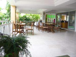 a restaurant with tables and chairs on a balcony at U.D.Home Apartment in Ban Chang