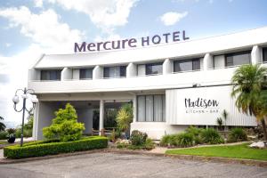 a large white building with a sign in front of it at Mercure Charlestown in Newcastle