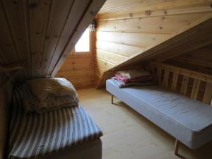 a bedroom with a bed in a wooden attic at Arctic Polar Holiday Village in Kilpisjärvi
