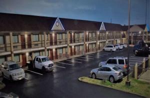 a parking lot with cars parked in front of a building at SureStay Hotel by Best Western Richland in Richland