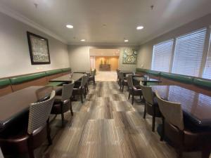 a restaurant with tables and chairs in a room at SureStay Hotel by Best Western Ontario Airport in Ontario