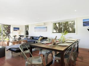 a living room with a table and chairs at Santa Barbara on Bombo Beach in Kiama