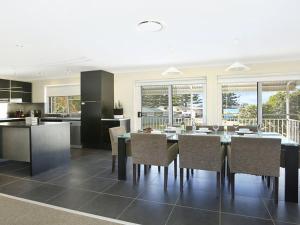 a kitchen and dining room with a table and chairs at Kendalls Beach House in Kiama