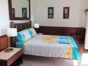 a bedroom with a bed with flowers on it at Daintree Riverview Lodges in Daintree