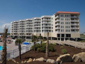 a large white building with palm trees in front of it at Ocean view, 2BR, 2BA Condo, St Regis 3213, Topsail, NC in North Topsail Beach