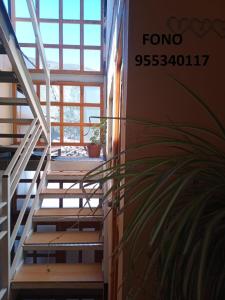 a set of stairs in a building with a window at Departamento supervisores in Diego de Almagro