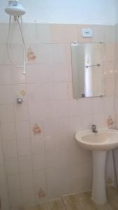 a bathroom with a sink and a mirror at Pousada Iguape in Iguape +35 photos