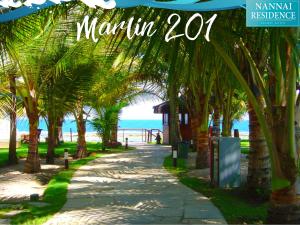 ポルト・デ・ガリーニャスにあるNANNAI RESIDENCE VISTA MAR Muro altoの浜辺のヤシの木が茂る遊歩道