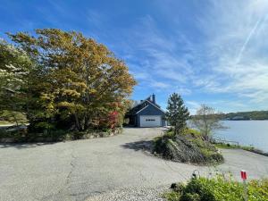 a house on the shore of a body of water at Spectacular home with a amazing ocean - river view in Groton