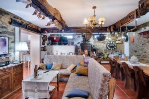 a living room with a couch and a table at Casa de Coelhosa in Vale de Cambra