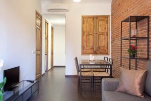 a living room with a table and a dining room at Modern 2-bedroom apartment near Sagrada Familia in Barcelona