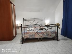 a bedroom with a bed with a wrought iron frame at Dimora dell'Isola Gallipoli in Gallipoli
