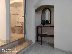 a bathroom with a toilet and a mirror at Dimora dell'Isola Gallipoli in Gallipoli